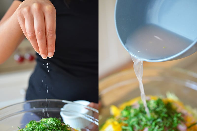 Seasoning the bowl of spicy mango cabbage slaw with salt and lime juice.