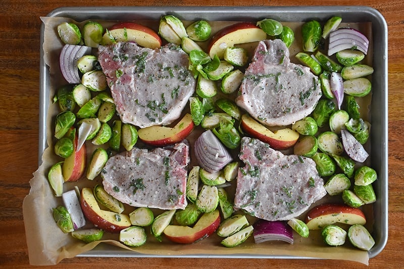 An overhead shot of Sheet Pan Pork Chop Supper ready for the oven