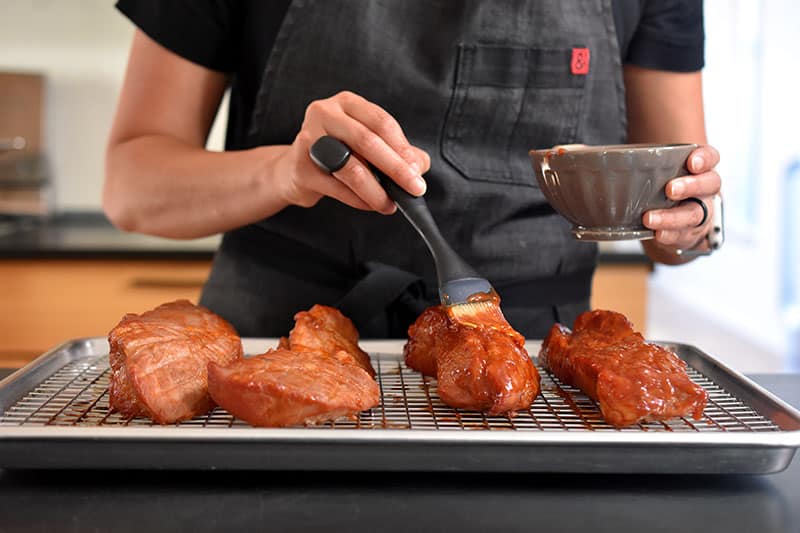 Brushing on additional marinade on the Paleo Char Siu (Chinese BBQ Pork) 