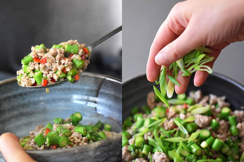 Transferring the Spicy Pork and Asparagus Stir-Fry to a serving bowl and topping it with sliced scallions