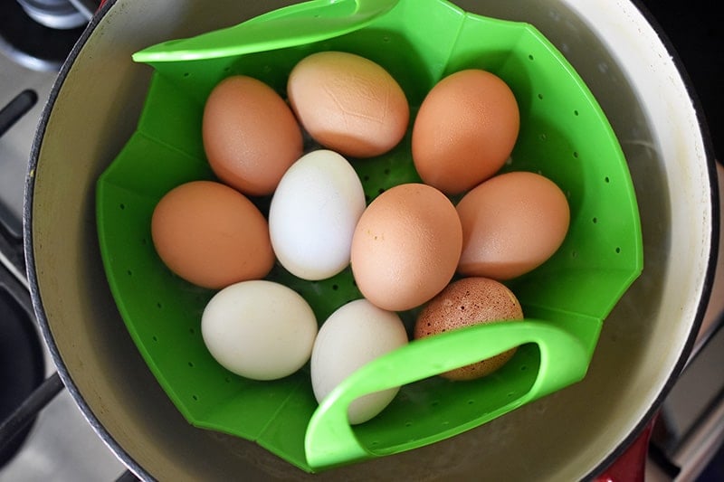 Eggs in a silicone steamer in an open pot.