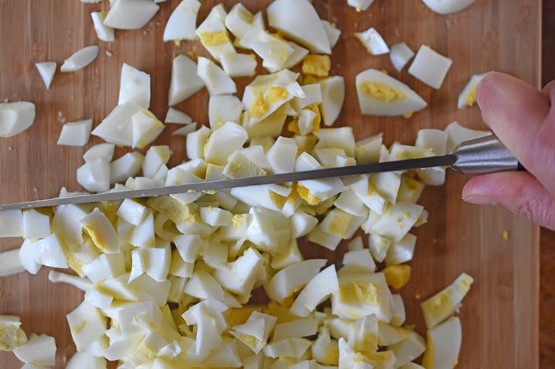 The hard cooked egg whites are chopped into small chunks.