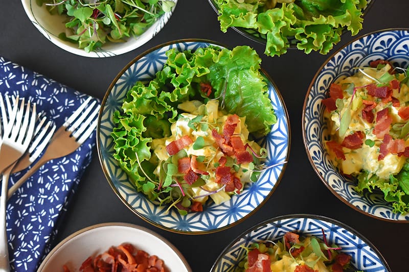 An overhead shot of Bacon Deviled Egg Salad divided into serving bowls.