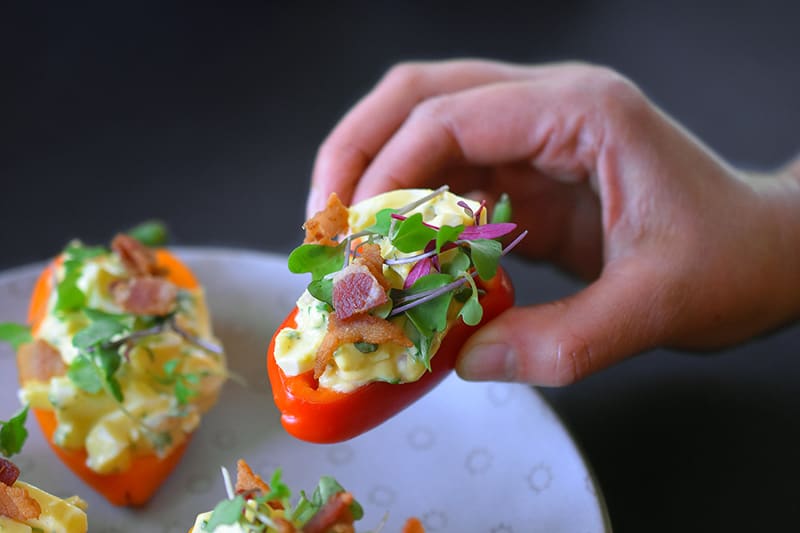 Bacon Deviled Egg Salad in small hollowed red bell peppers.