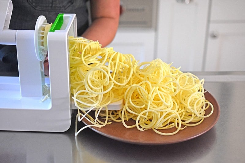 A spiralizer making sweet potato noodles for Paleo Chicken Chow Mein 