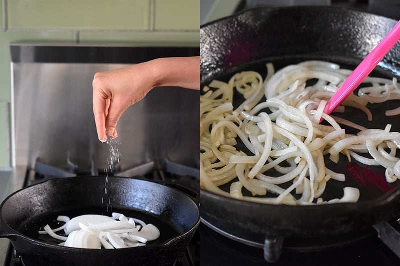 Sprinkling salt on some thinly sliced onions that are sautéing in a cast iron skillet.
