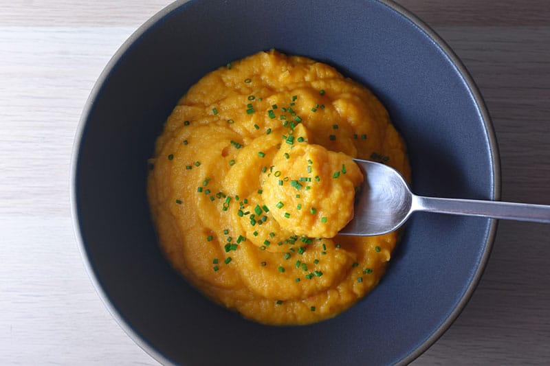 A bowl of paleo and Whole30 Instant Pot Autumn Mash with a spoon.