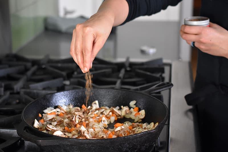 The vegetable filling for Italian Sausage + Kale Casserole is seasoned with a sprinkle of Nom Nom Paleo's Magic Mushroom Powder.
