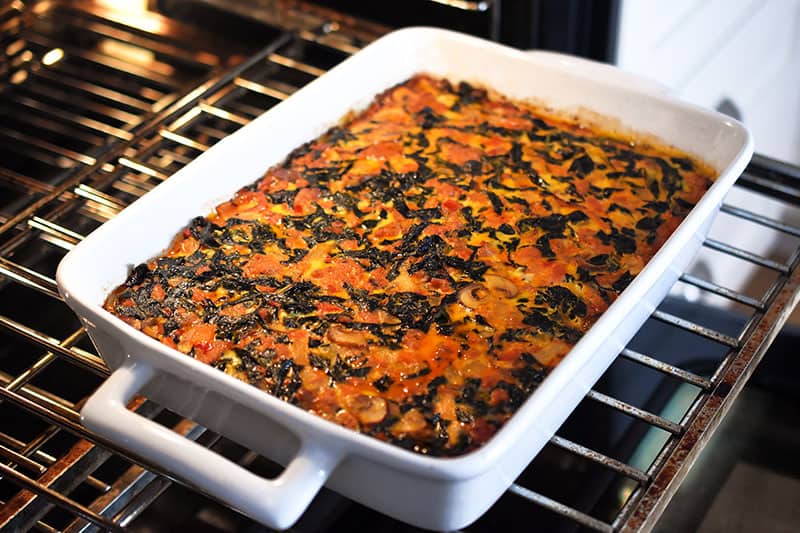 A side shot of the Italian Sausage + Kale Casserole coming out of the oven.