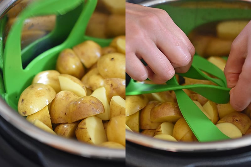 An open Instant Pot with cut potatoes in a green silicone steamer. 