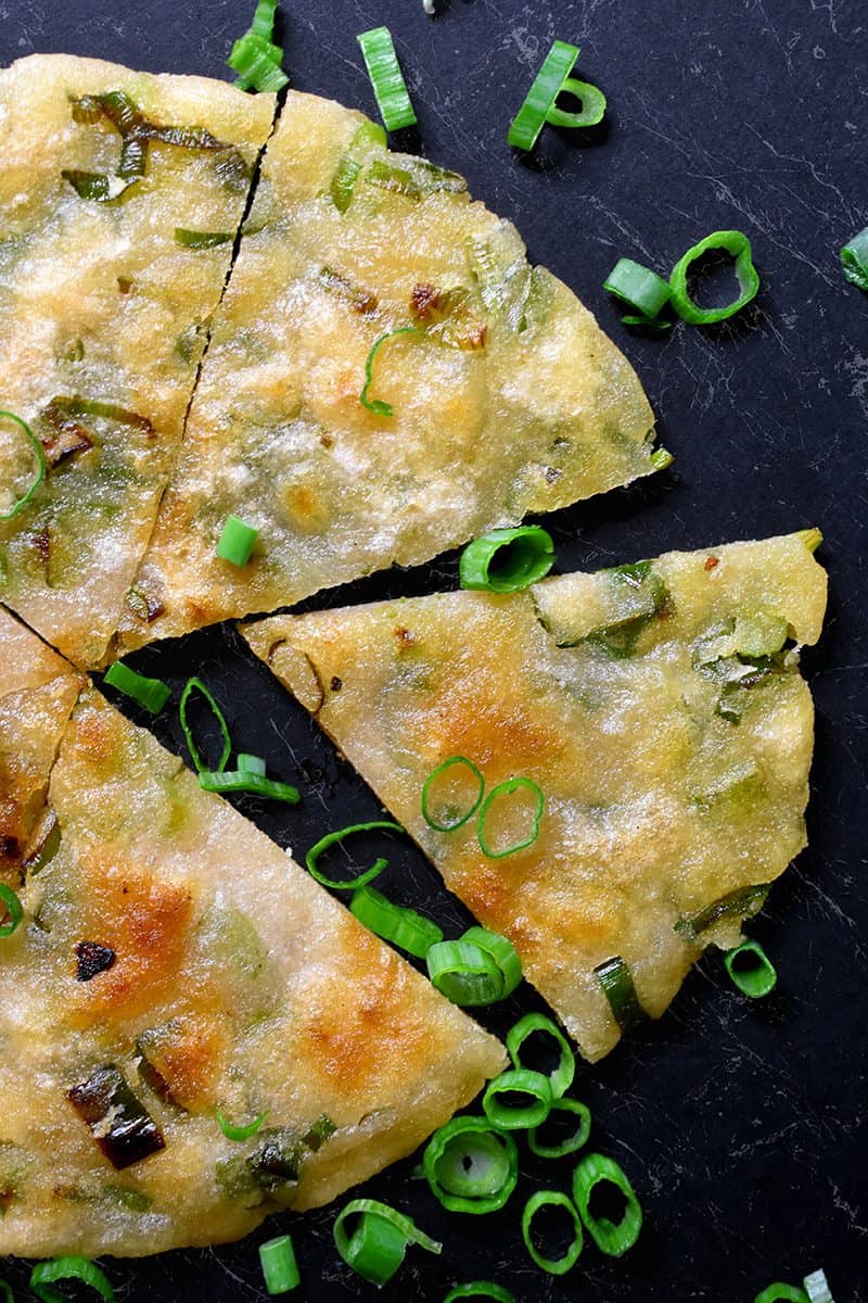 An overhead shot of a Paleo Scallion Pancake cut into wedges.