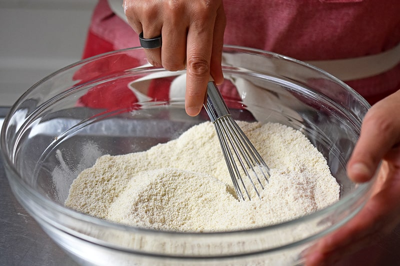 Whisking the dry ingredients for a paleo and gluten free berry snack cake.