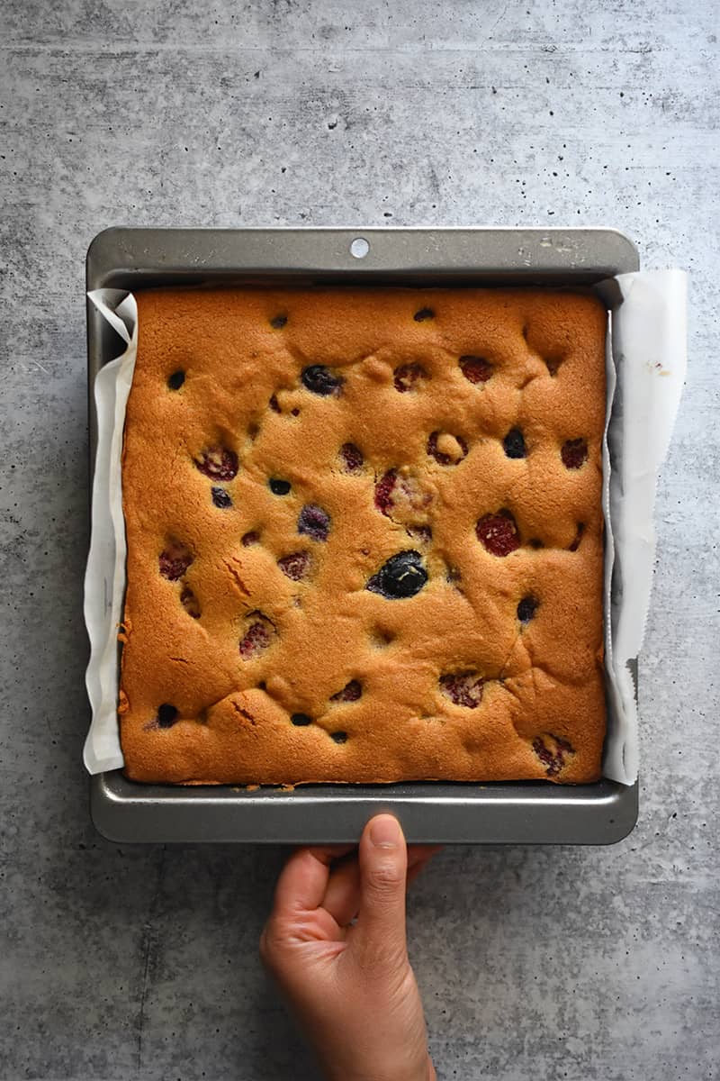 An overhead shot of paleo and gluten free berry snack cake right out of the oven.