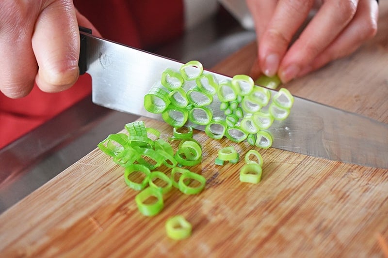 Someone chopping green onions.