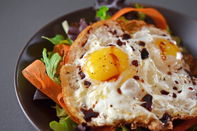 A finished Sunnyside Salad in a brown serving bowl.