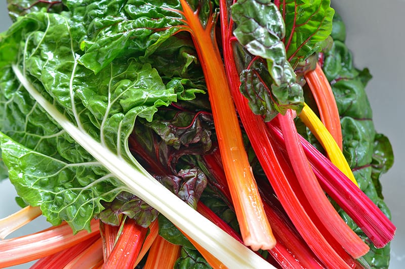A pile of washed rainbow swiss chard.