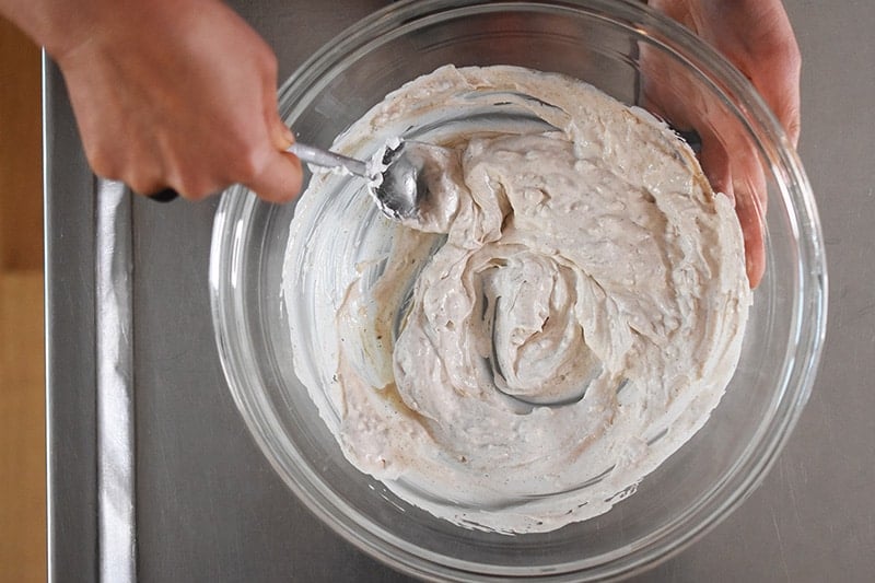 An overhead shot of the marinade for Umami Roast Chicken being stirred together with a spoon.