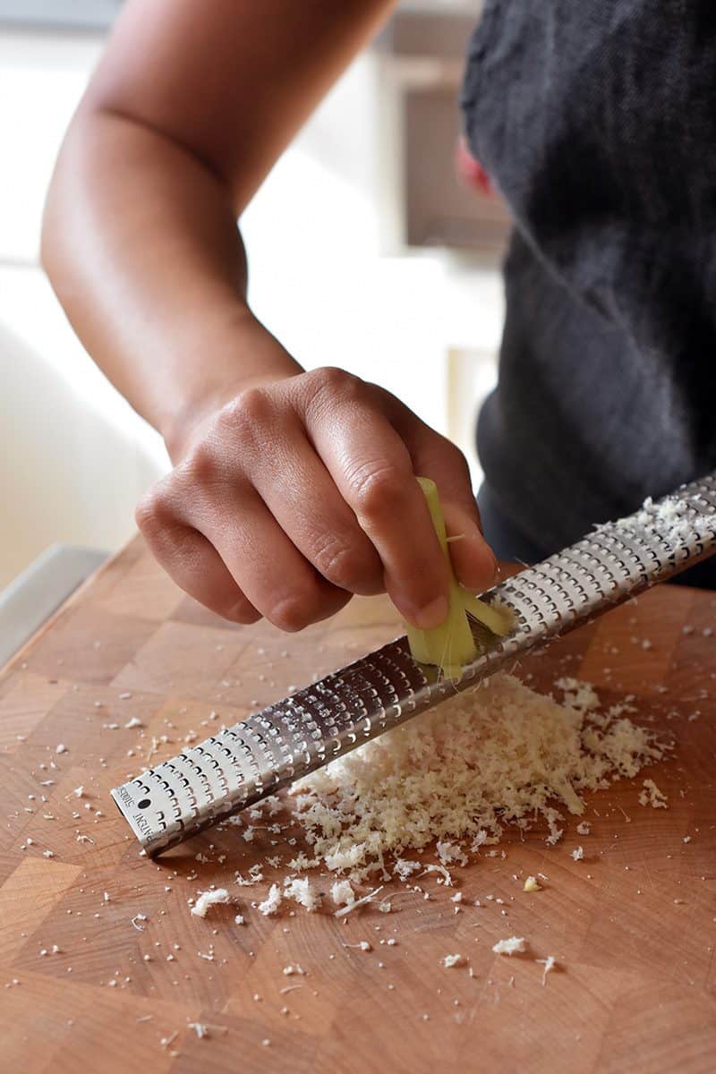 Using a microplane rasp grater to finely cut lemongrass.