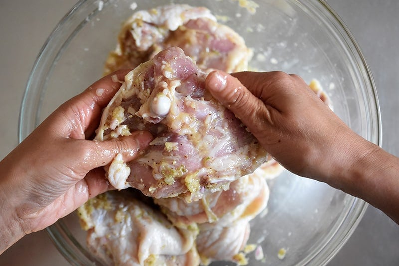 Massaging the chicken thighs with the Vietnamese Lemongrass Chicken marinade