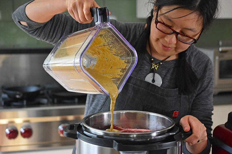 Pouring the marinade over the Instant Pot Korean Short Ribs 