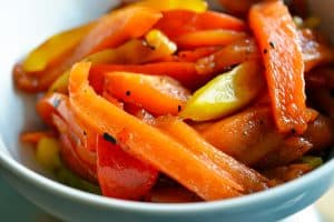 A bowl of paleo roasted bell peppers with balsamic vinegar and extra virgin olive oil.