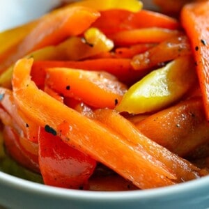 A bowl of paleo roasted bell peppers with balsamic vinegar and extra virgin olive oil.