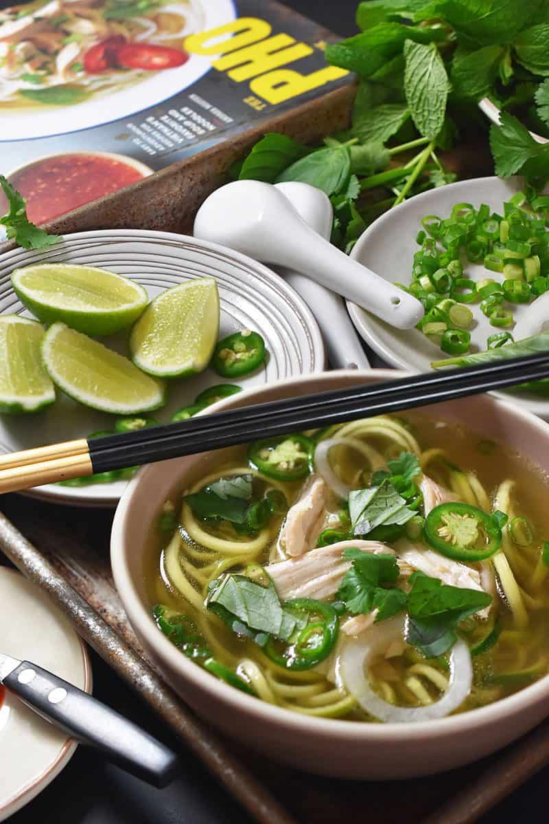 An overhead shot of a table filled with bowls of Instant Pot (Pressure Cooker) Chicken Pho 