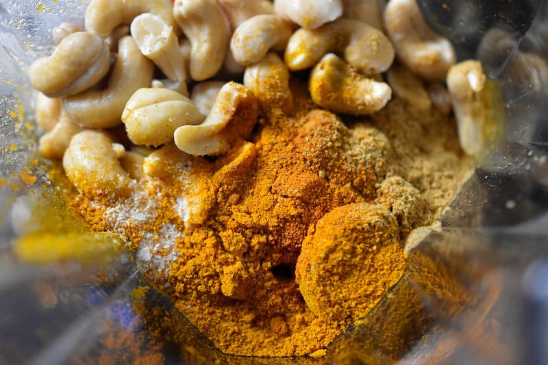 An overhead shot into the blender that has the ingredients for the paleo sweet potato and cashew dip.