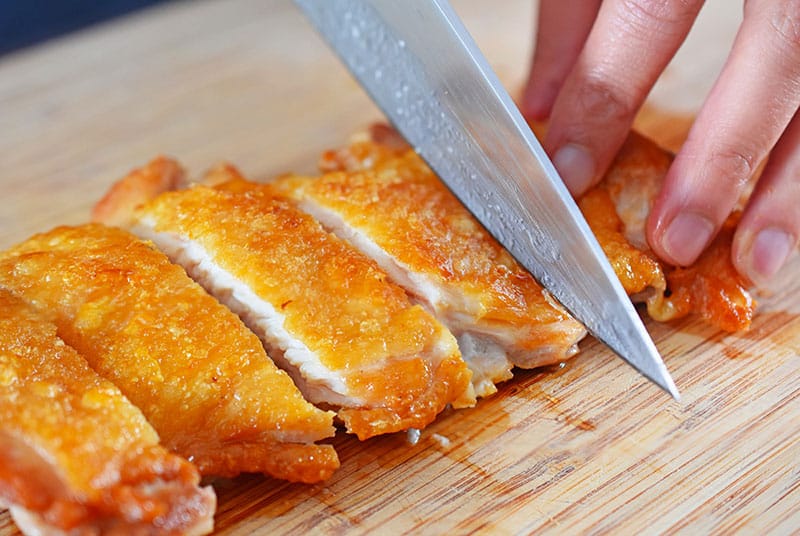 Cutting a piece of Whole30, keto, and paleo-friendly Cracklin' Chicken for Chinese Chicken Salad
