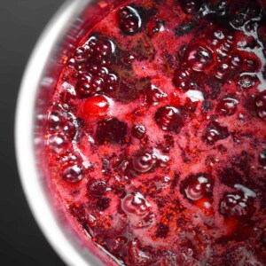 An overhead shot of paleo cranberry sauce simmering in a saucepan