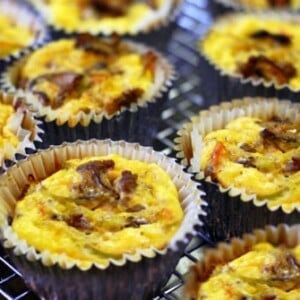 Curried beef, broccoli slaw, and mushroom frittata muffins sitting on a cooling rack.