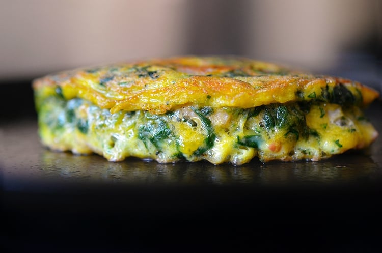 A side view of Egg Foo Young-ish (Spinach, Egg, Ham & Coconut Pancakes) on a plate.