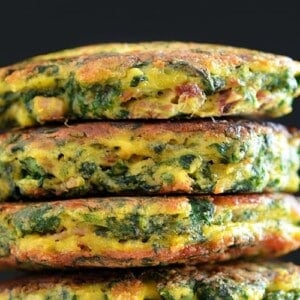 A stack of paleo egg foo young against a black background