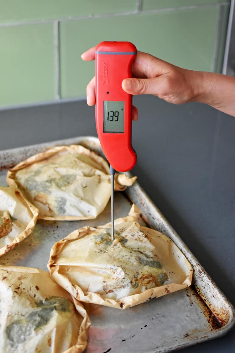 Checking the temperature of the fish in Fiona’s Phenomenal Fish Packets with a meat thermometer.