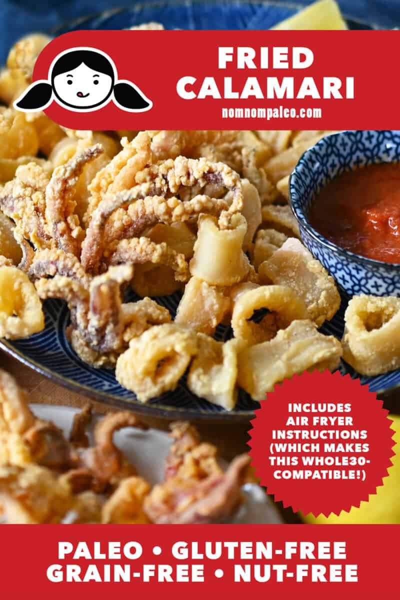 A shot of platters of paleo fried calamari next to small bowls of marinara and sliced lemons