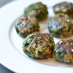 Mini beef burgers on a plate.