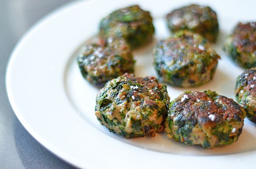 Mini burgers with beef and spinach on a plate.