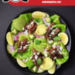 An overhead shot of a plate of crispy Nom Nom Paleo Instant Pot Carnitas. There is also a red banner that says paleo, gluten-free, and low carb