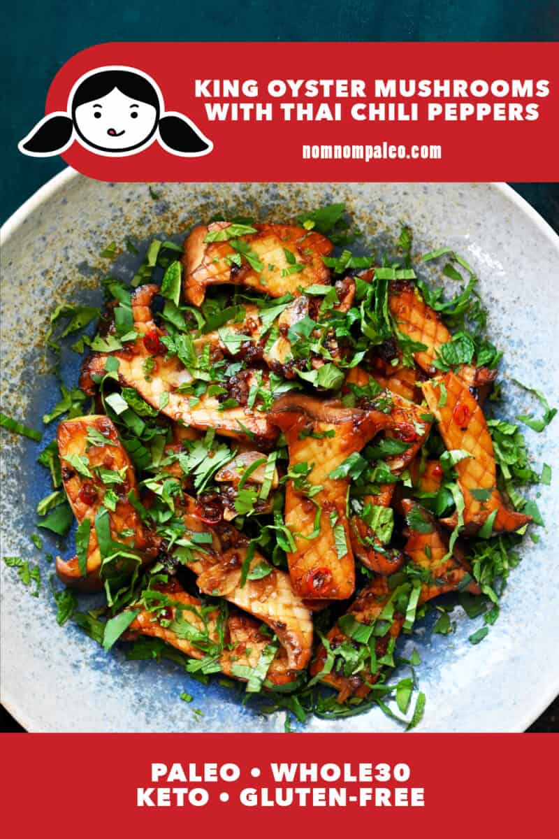 An overhead shot of king oyster mushrooms with Thai Chili peppers, lime juice, and fresh herbs in a light blue bowl.