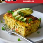 A closeup of a slice of Whole30 and low carb Mexican Breakfast Casserole with slices of avocado on top. There is a red banner at the bottom that reads "Paleo, Whole30, Low Carb, and Gluten-Free"
