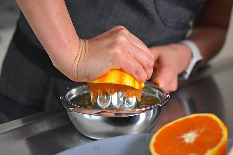 Juicing the zested oranges for the Instant Pot Carnitas