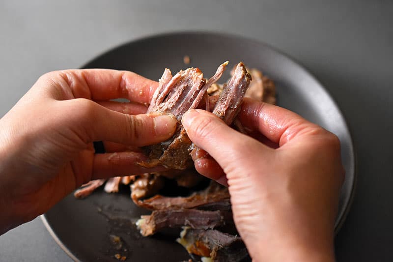 Shredding cold Instant Pot (Pressure Cooker) Carnitas by hand.