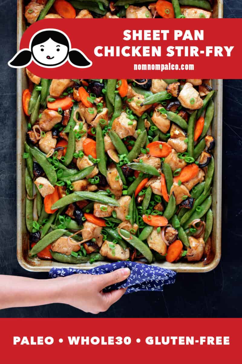 An overhead shot of sheet pan chicken stir-fry fresh out of the oven. A hand is holding the edge of the pan with a towel. The red banner at the bottom reads paleo, Whole30, gluten-free.