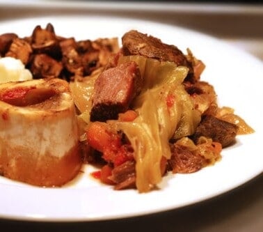 A plate of paleo grass fed beef shanks with cabbage stew.