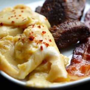 A plate of sous vide eggs with bacon.