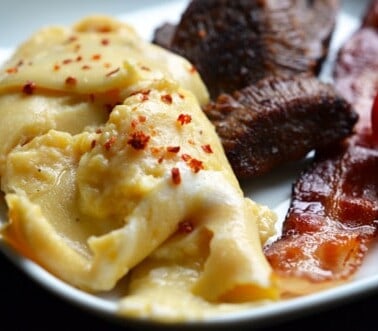 A plate of sous vide eggs with bacon.