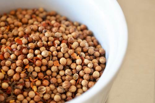 Letting the toasted spices cool in a small bowl.