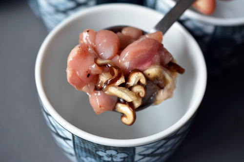 Spooning the chicken, shrimp, and mushrooms mixture into the 8 ounce cups for paleo chawanmushi.