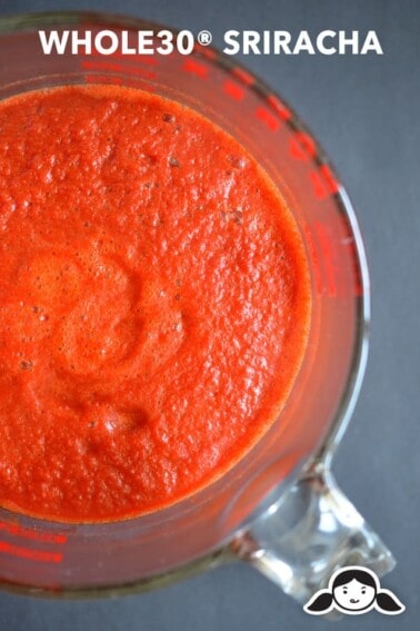 An overhead shot of Whole30 sriracha in a liquid measuring cup.