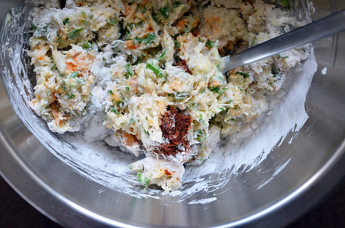 A crab cake mixture in a metal bowl for Thai Curry Crab Cakes to Go.